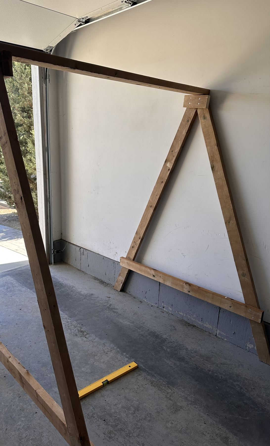 Finished self-supporting wooden swing frame during assembly