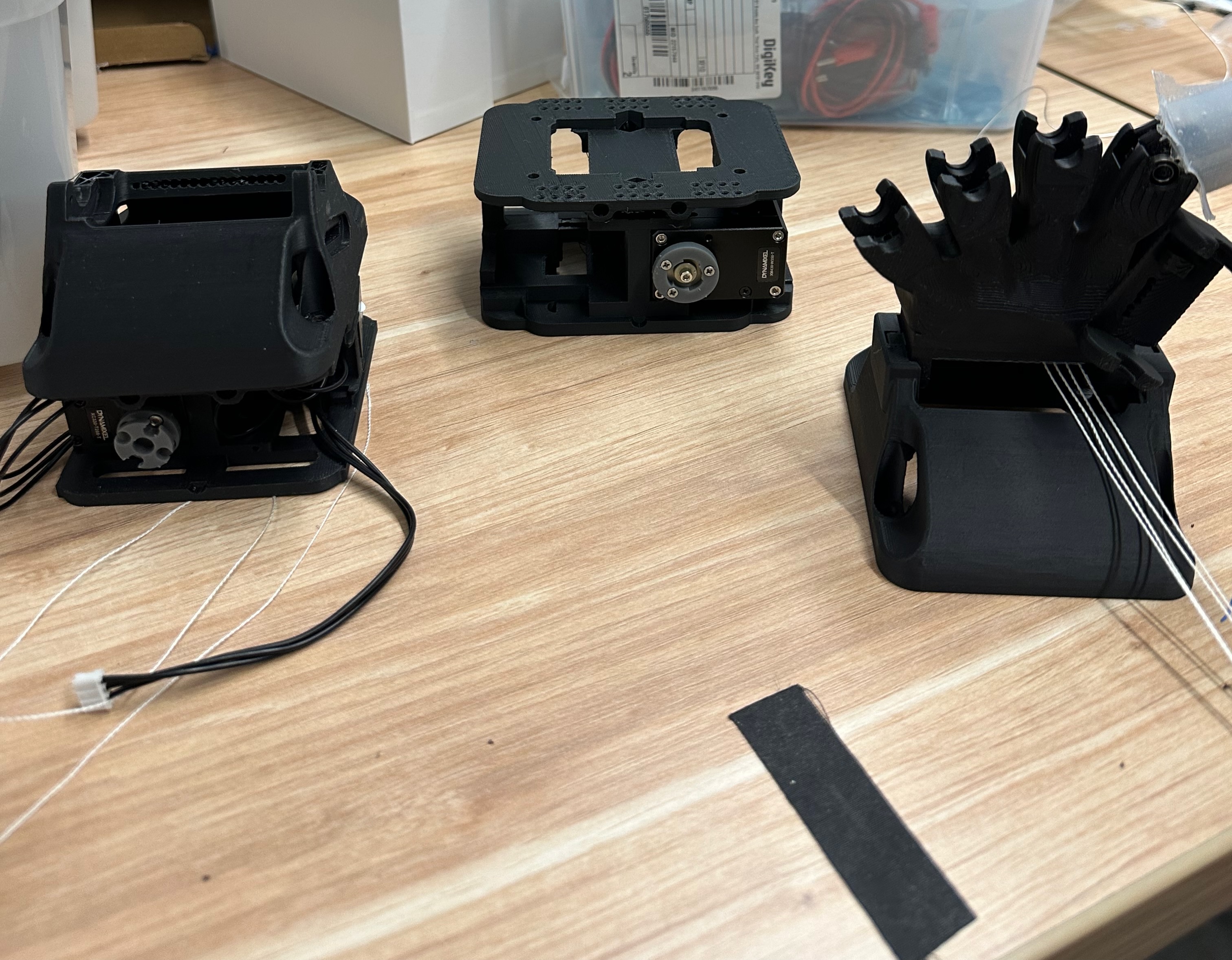 Three robotic hand actuator housings used while comparing XC430 and XC330 Dynamixel servos