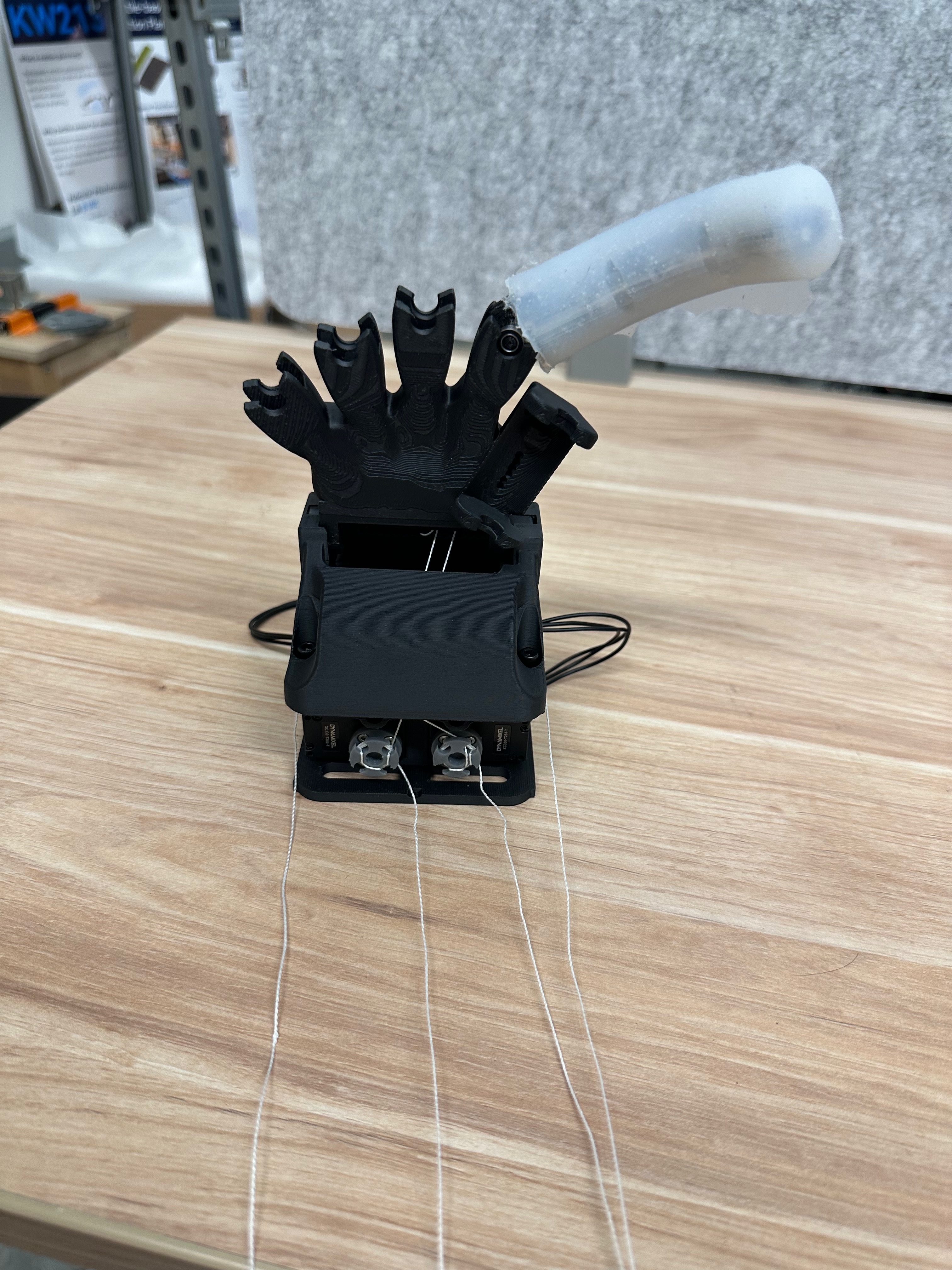One-finger robotic hand test setup with a custom silicone-moulded finger and tendon actuation